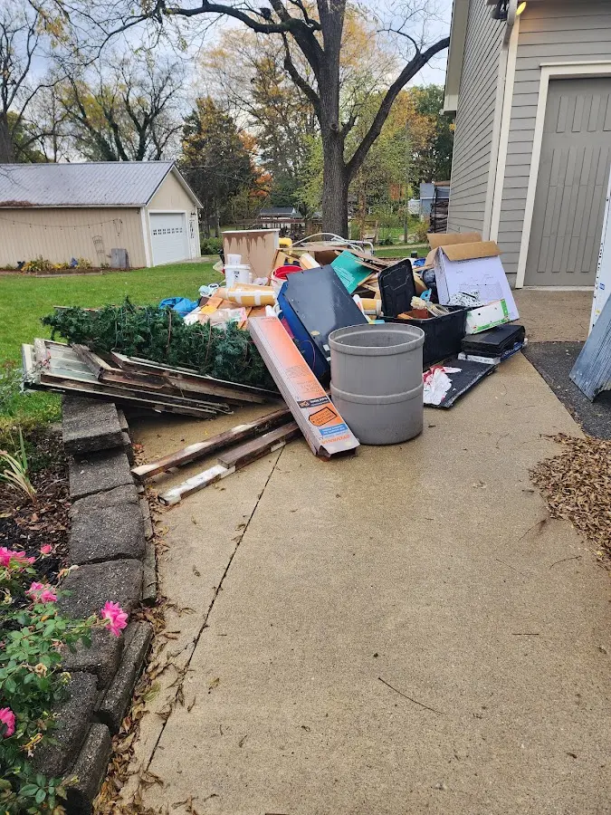 Dumpster being loaded with debris for Estate Cleanout Dumpster Rental in Woodbury Heights